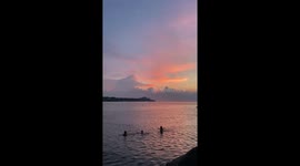Distant thunderstorms beneath pastel skies in Cleveland, Ohio