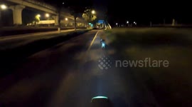 Owner races with his pet dog through deserted park at midnight