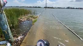 Flooded Road Blocks Way To School And Market