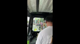 Kind locals help elderly woman cross busy road