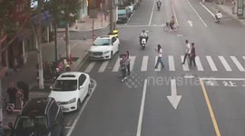 China: Motorcyclist Looking At Phone Hits Woman On Crosswalk Also Looking At Phone