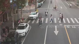 Motorcyclist and pedestrian distracted by phones collide on zebra crossing