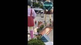 Workers test giant Squid Game 'jump rope' replica in Bangkok