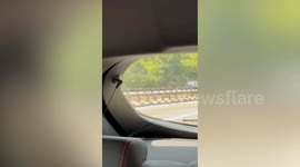Car whizzes wrong way down busy London A-road - as cars scramble to avoid collison
