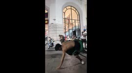 Man performs breakdance with chair on a street in Tianjin, China