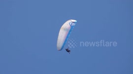 Paraglider performs safety drill simulating a canopy failure