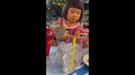 Helpful little girl pours drinks for her whole family