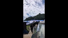 Residents battle vehicle fire on roadside in Indonesia