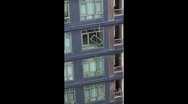 Storm damages apartment block windows in Bangkok