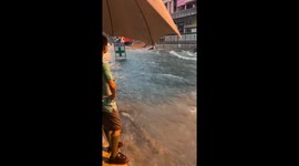 Clinic sign floats away as floods turn streets into raging rivers in Thailand