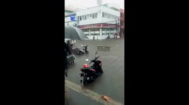 Parked cars and motorcycle submerged in floodwater amid storm in Philippines