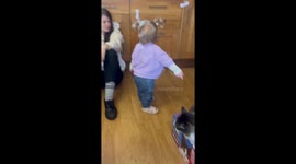 Cute toddler playfully talks to older sister in Wales, UK