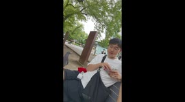 Man shares snack with pigeons in Shanghai, China