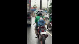 Pet dog rides in owner's backpack on motorcycle