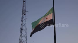 Syria: The Syrian independence flag flies at night above Saadallah al-Jabri Square in Idlib