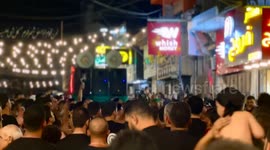 Lebanon: Men raise their hands to beat their chests in mourning for Imam Hussein during a Muharram procession in Nabatieh