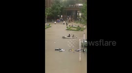 Locals forced to use kayak to navigate streets as floodwater submerges Chinese city