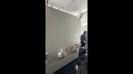 Plane passenger sticks her smelly feet through seat gap in front