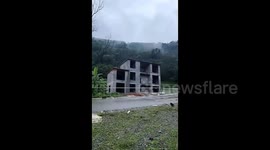 Five-storey homes collapses into river after torrential rain swells river in China
