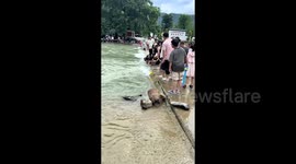 Boy swept into bridge drain by raging current is rescued by human chain in China