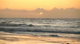 Sunset and strong waves at Surfside Beach, South Carolina, USA