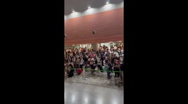 Crowded scene at Terminal 4 in Barajas Airport, Madrid, Spain