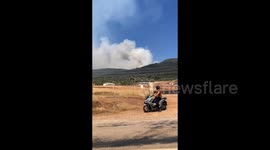 Türkiye: A man observes smoke and flames from a wildfire in the Seferihisar district