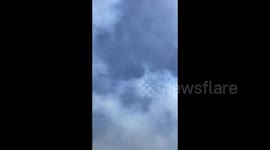 Türkiye: A firefighting helicopter drops water while smoke rises from a wildfire in the Seferihisar district of Izmir