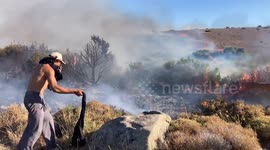 Türkiye: Volunteers attempt to extinguish a wildfire in the Cesme district of Izmir