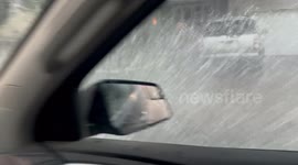 Minnesota motorist forced to pull over as thunderstorm batters his car