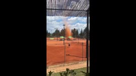 Man disperses dust devil with water hose in Samobor, Croatia