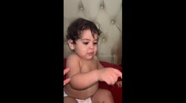 Little Boy Trying His Best to Blow Out Candles