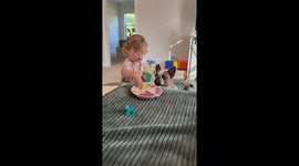 Little girl gently spoon-feeds dogs during mealtime in Seneca, South Carolina, USA