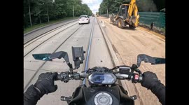 Motorcyclist tips over near a concrete curb in Moscow, Russia