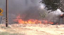 US, Los Angeles: Lancaster Structure Fire With Grass Spread