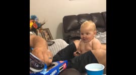 Little girl eagerly anticipates her next Oreo cookie while holding one in her hand