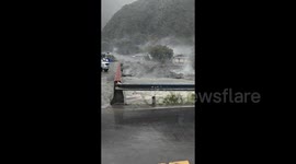 Terrifying moment powerful mudslide sweeps village homes into river in China