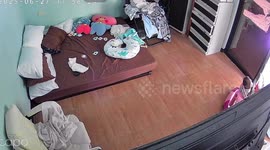 Baby has a near miss when electric fan falls on his face