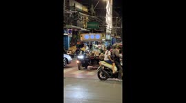 Street food seller drives cart with eight cats perched inside