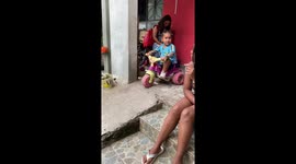 Toy tricycle mishap sends girl tumbling in Belo Horizonte, Brazil