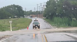 US: Vehicles Drive Through Flooded Intersection in Williamson County, Texas