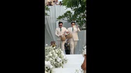 Couple's friends serve as 'flowermen' dispensing blossom at wedding