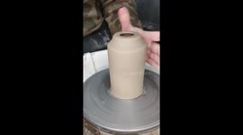 Satisfying pottery art process as an artist trims and designs a clay lantern