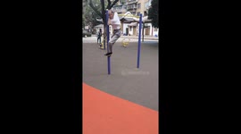 Older Man Swings in Circles on Horizontal Bar