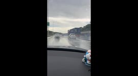 Driver manually wipes windshield with hand on highway in Guangdong, China