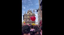 Crowd celebrates San Fermín at Town Hall Square in Pamplona, Spain