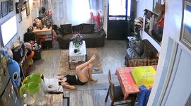 Woman distracted by yoga startled when boyfriend walks in unnoticed