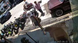 Pensioner falls backwards as she walks across metal grille to cafe