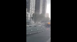 Storm blows over road barriers and signs in China