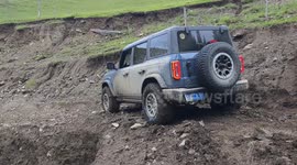 Driver navigates collapsed road in off-road vehicle in Xinjiang, China